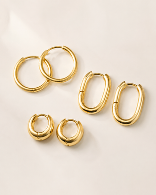 Three gold hoop earring styles in The Everyday Hoops Bundle on warm ivory.