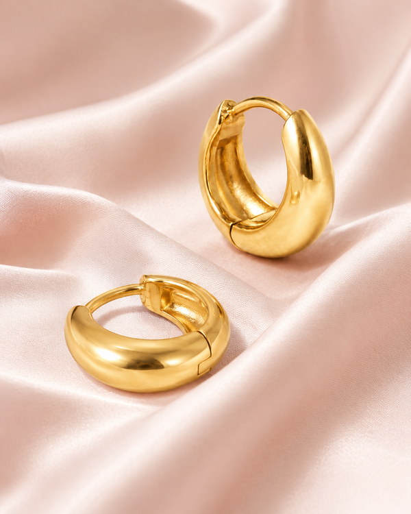 Bold Hoops styled on soft blush satin.