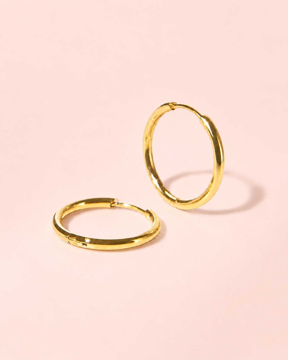 Classic Everyday Hoops angled product view on soft blush. styled