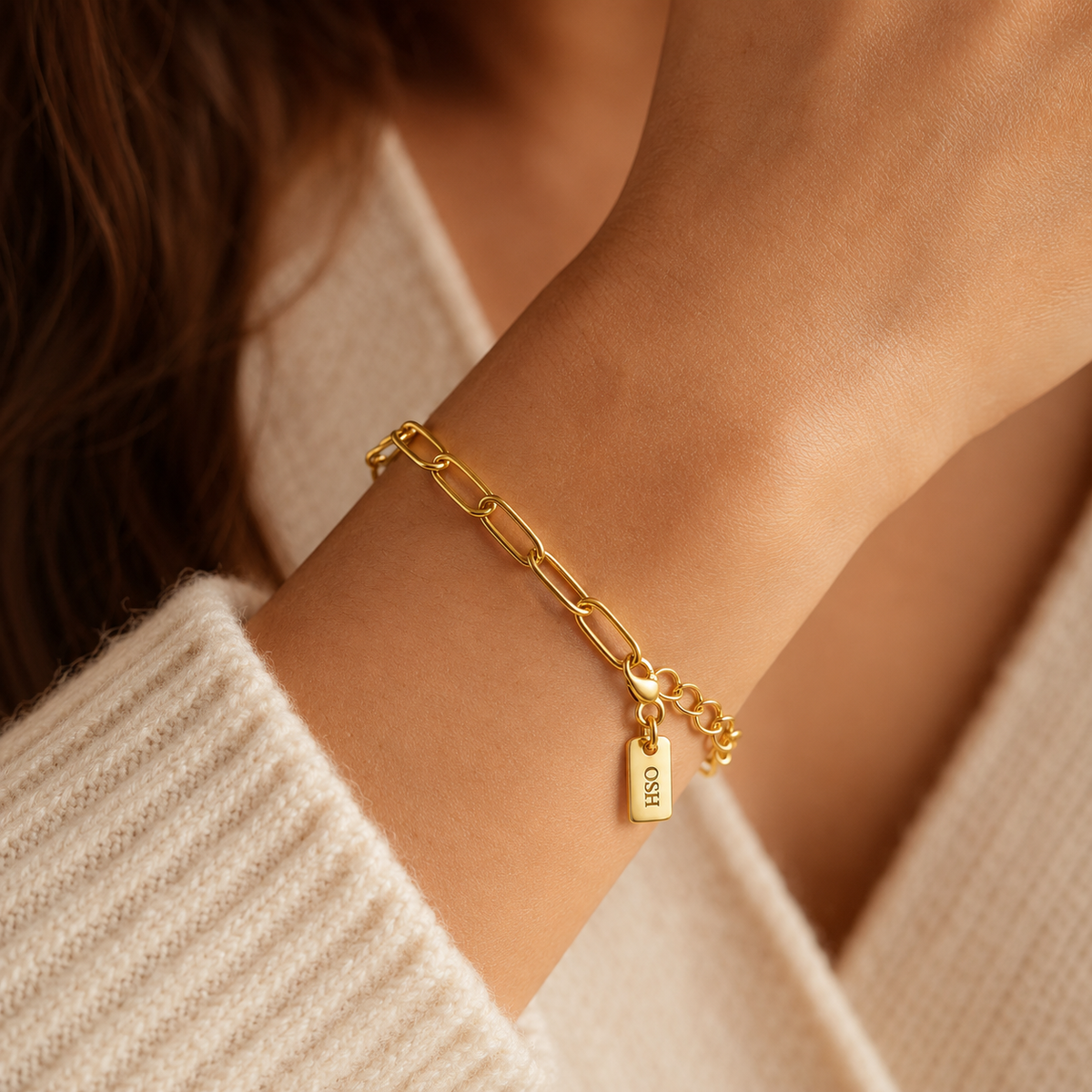 Soft Link Bracelet worn on wrist with cream knitwear.